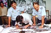 Sqn Ldr P K Sharma and Chandla with a visitor poring over a map